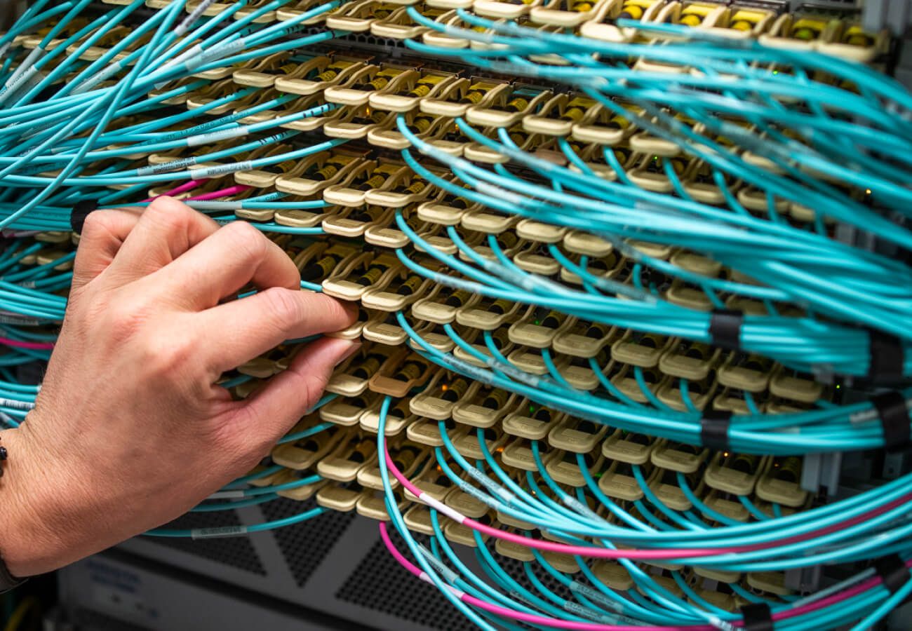 Network technician maintaining high-performance server infrastructure