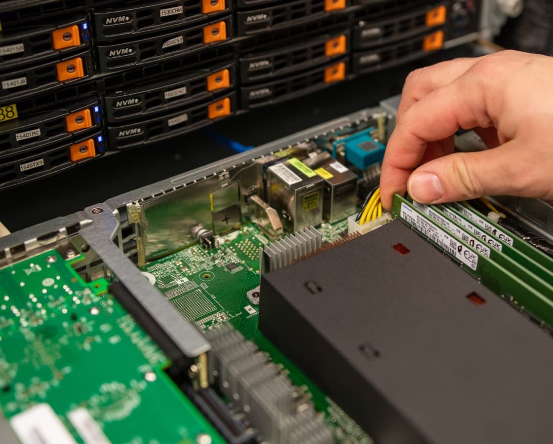 Datacenter employee performing server rack maintenance